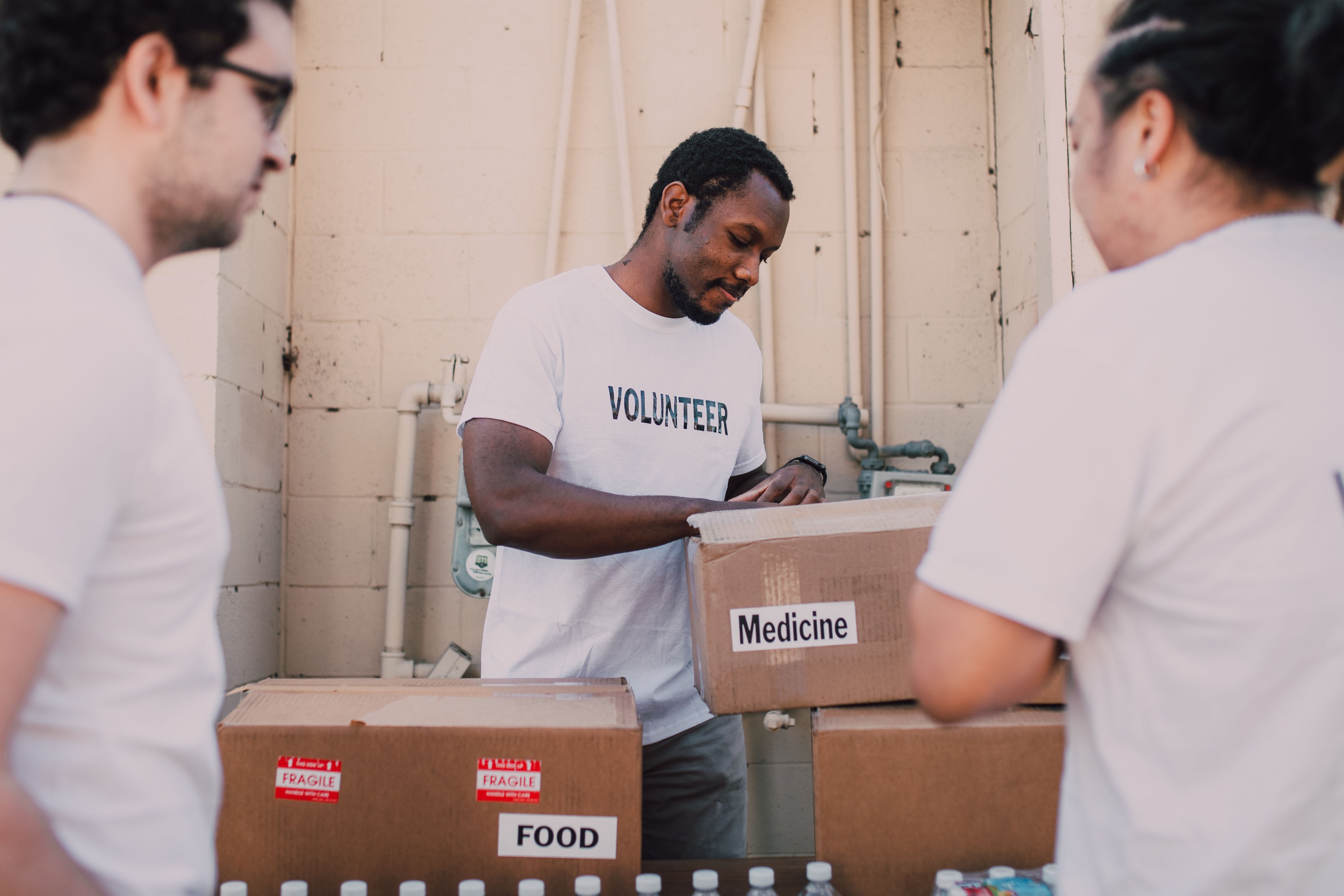 Volunteers organizing labelled boxes and supplies.